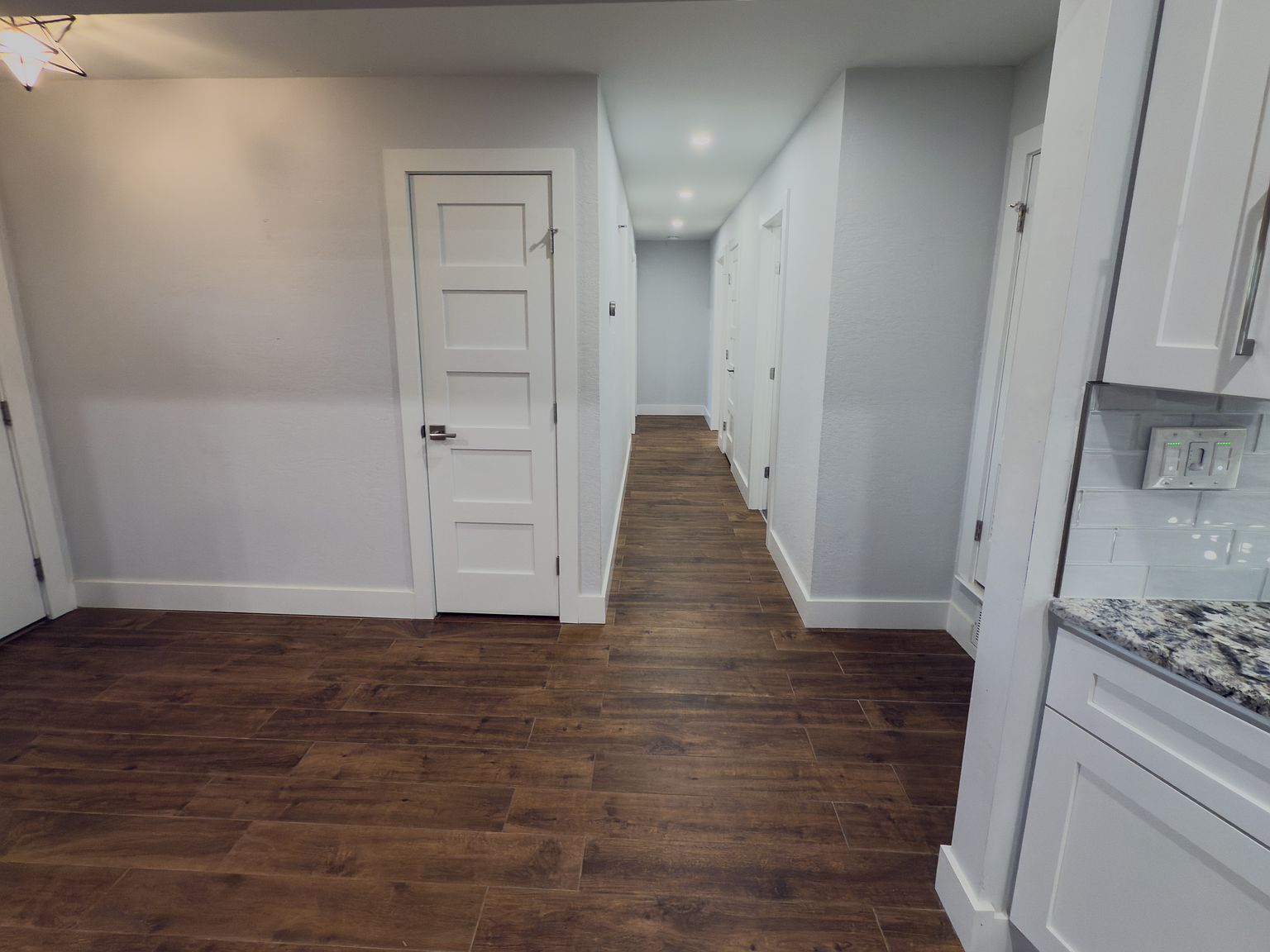 Hallway with hardwood floors connecting bedrooms and bathrooms - 2006 Candle Ct