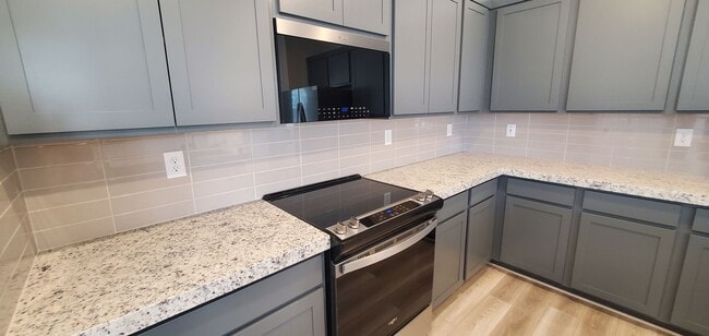 Building Photo - Beautifully designed modern townhome with attached garage.