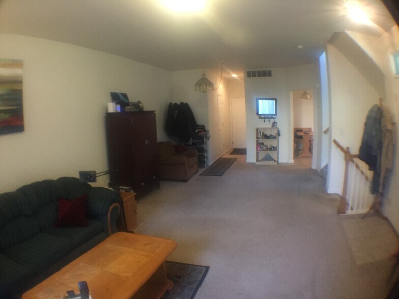 Another view of the living room, with view of kitchen, and hallway to laundry, 1/2 bath, and garage. - 2850 Kansas Dr Unit D