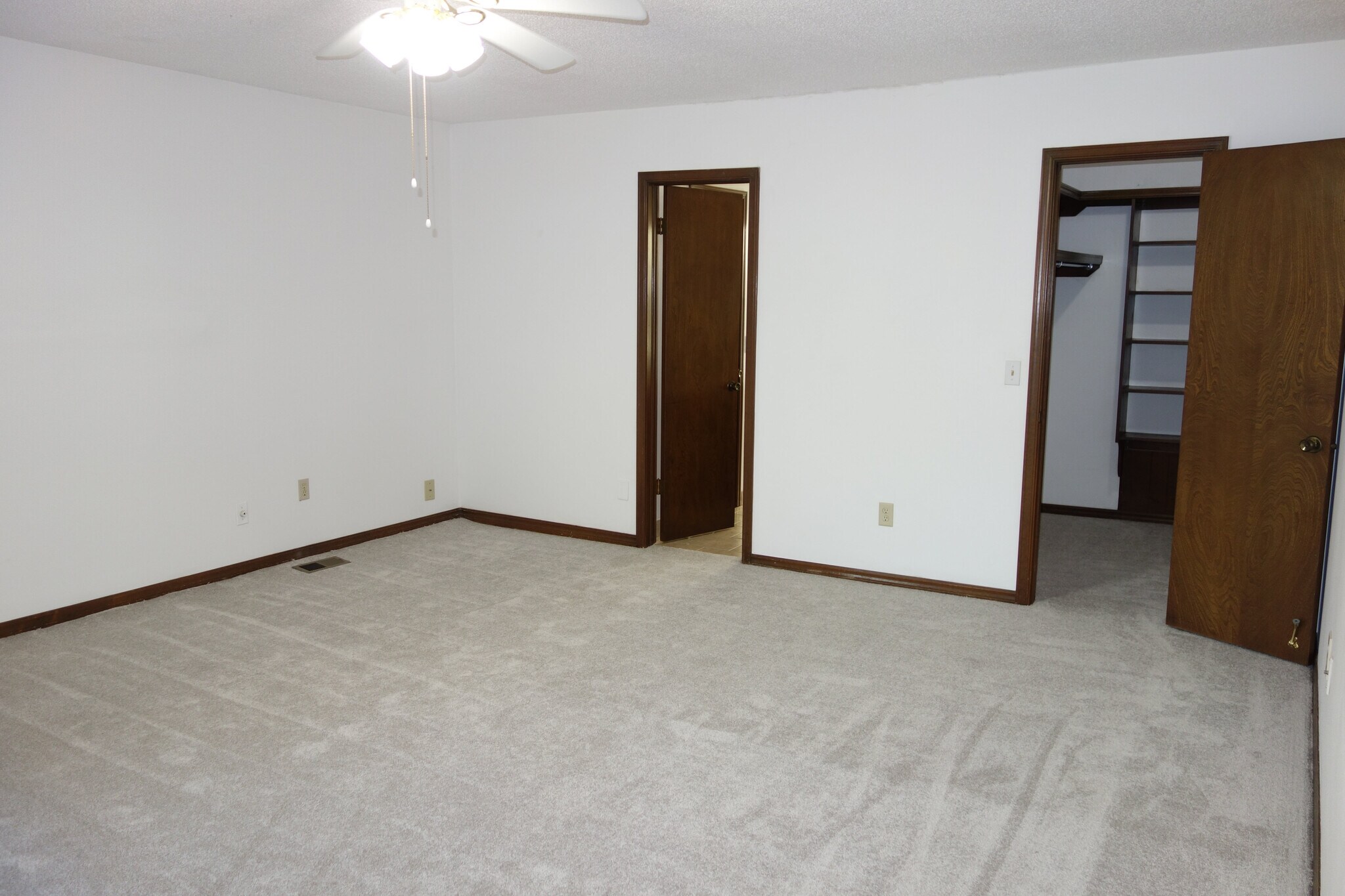 Master bedroom with view of master bath on left and large walk-in closet on right - 3324 E 73rd St