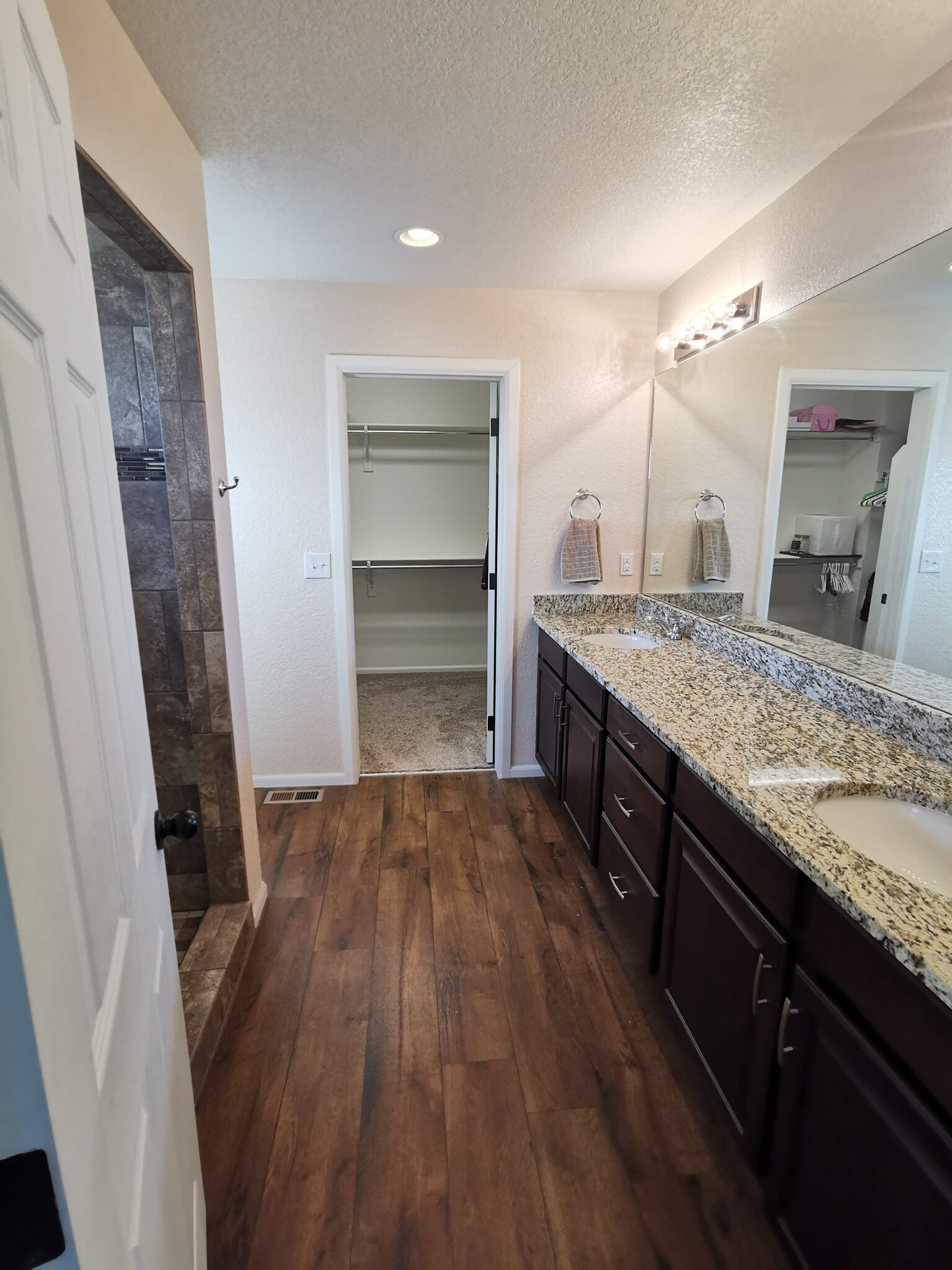 Master bath with large walk in shower and double vanities - 17778 E 44th Ave