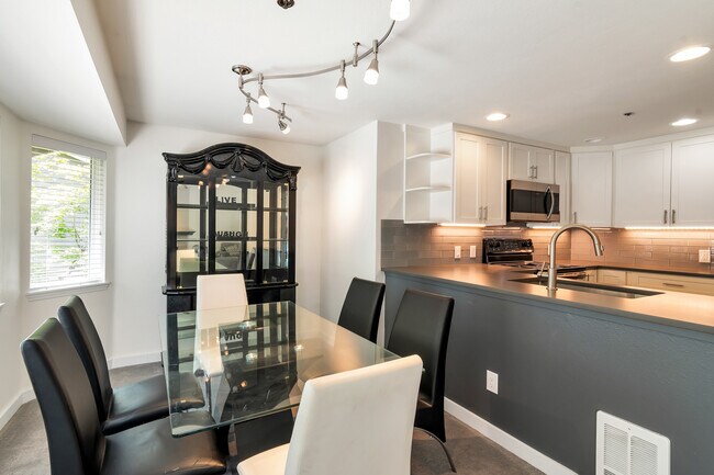 Dining room with a view into the kitchen. - 19404 Bothell Way NE