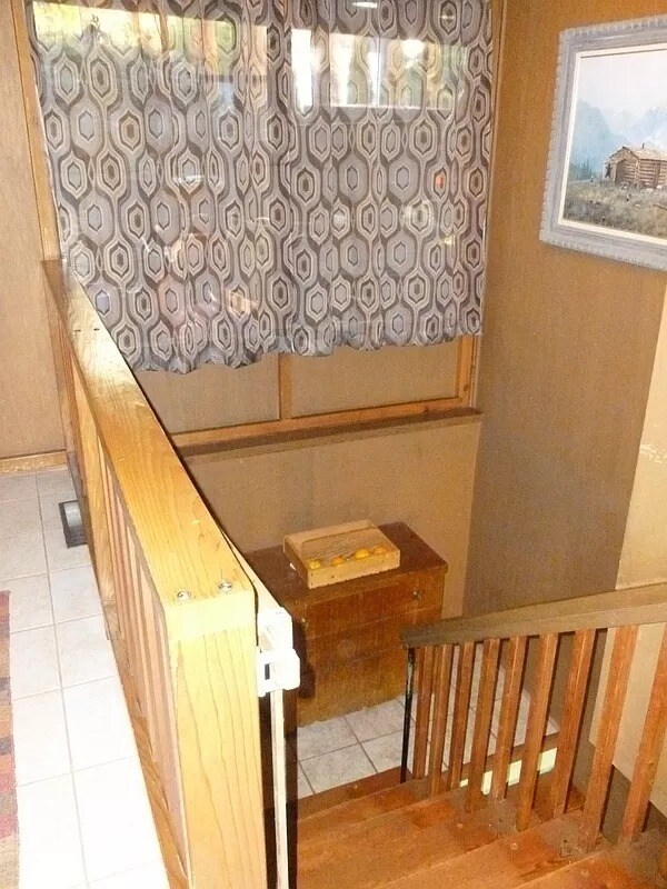 A look at part of the entryway and heading downstairs past the landing. - 1705 NE Lower Dr