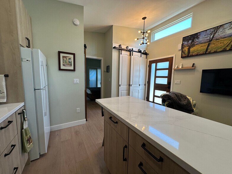 kitchen area overlooking living room, kitchen island and looking towards Bedroom 1 - 1490 Ash St