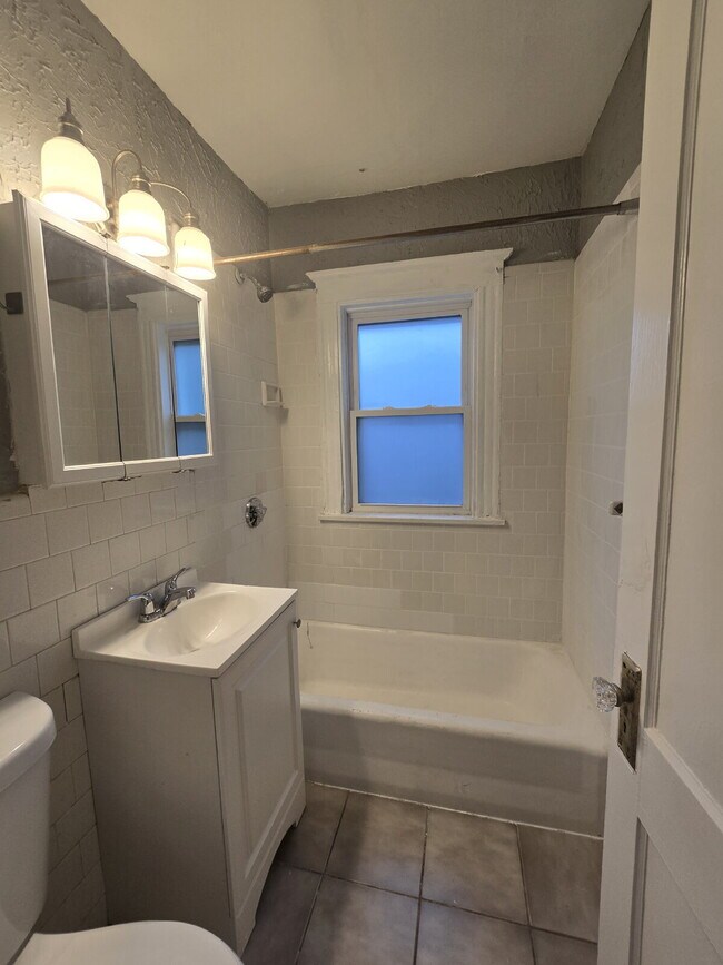 Building Photo - "Charming 2-Bedroom First-Floor Gem with Electric, Water, Free Laundry, Garage Parking, Landscapi...