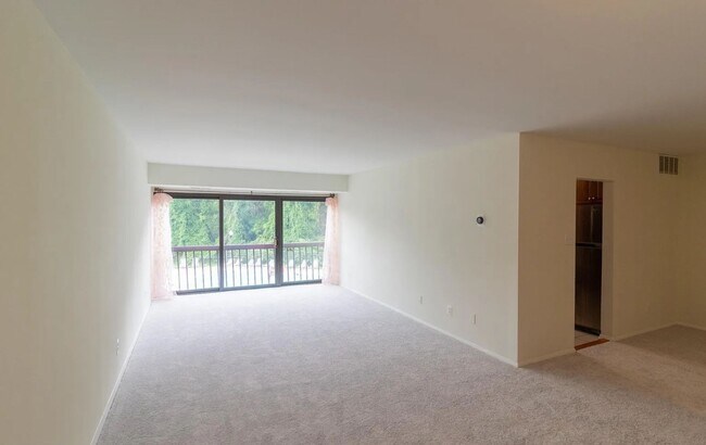 Living room with a view to the pool and the trail - 12730 Veirs Mill Rd