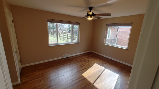 Bedroom 1 with blackout shades, ceiling fan and double closets - 6934 Winding Way