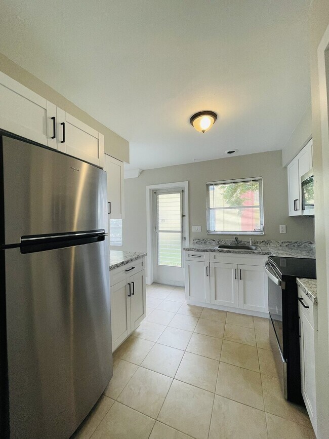 Building Photo - Updated 2-bedroom waterfront duplex with walk-in closets, enclosed Florida room, and canal views ...