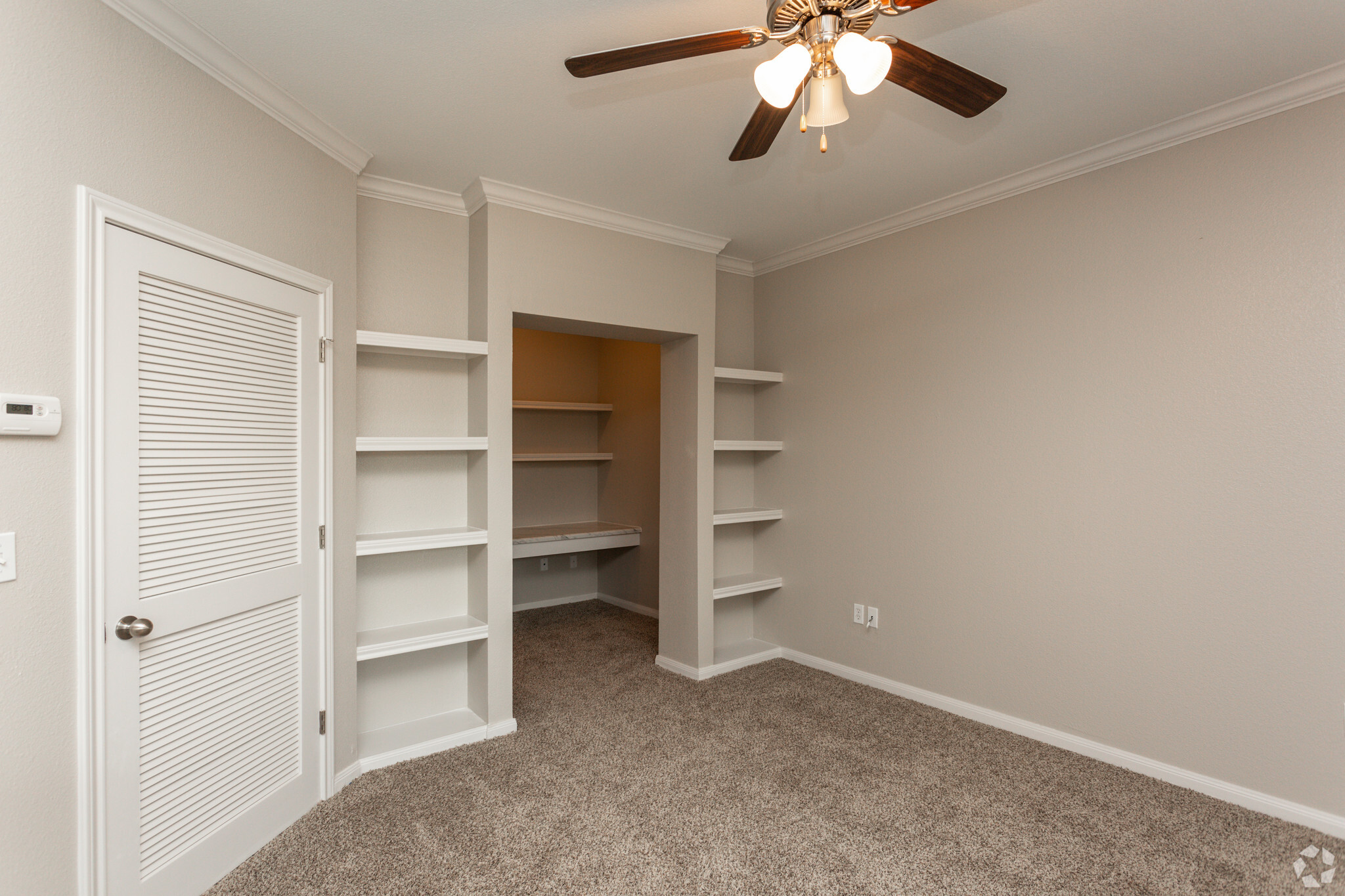 1BR, 1BA - 843SF Living Room With Built-In Shelving - The Oaks at Bentwater