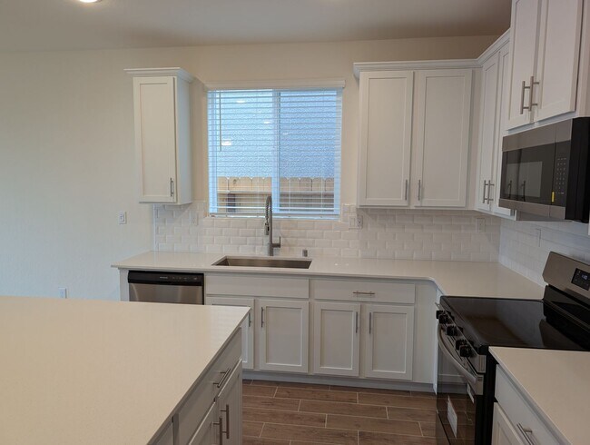 Building Photo - New Wilson home offering modern amenities, solar and a nice floor plan. Bonus room with den or of...