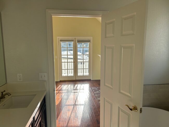 Primary bathroom looking into Primary bedroom with french doors to balcony - 1713 Goodman Ave