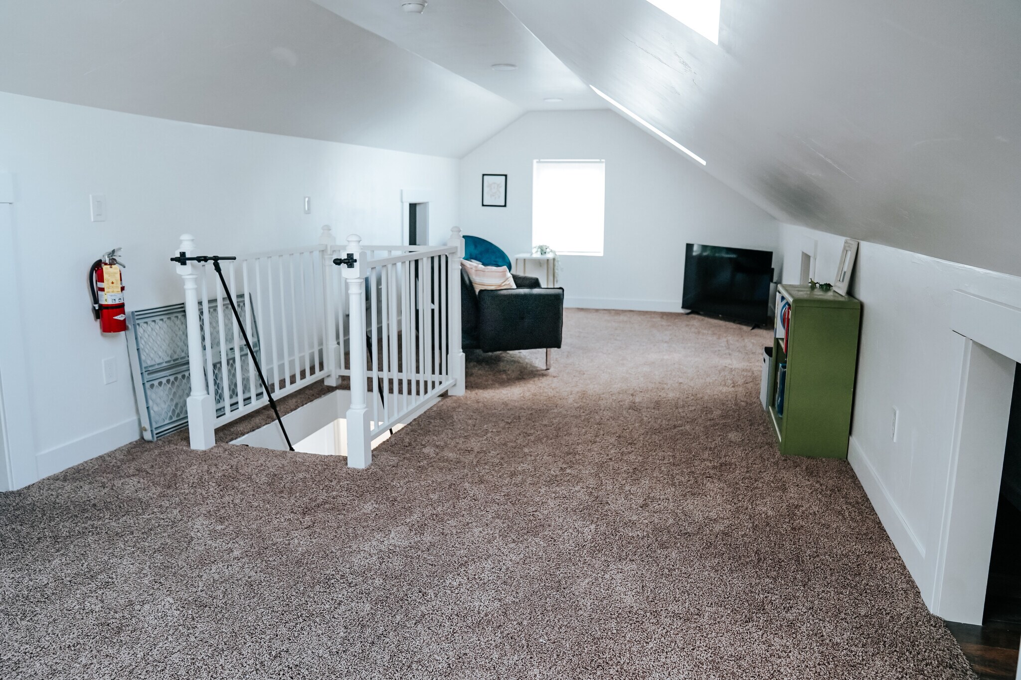 upstairs bonus room with television and games plus extra storage - 525 8th Ave W