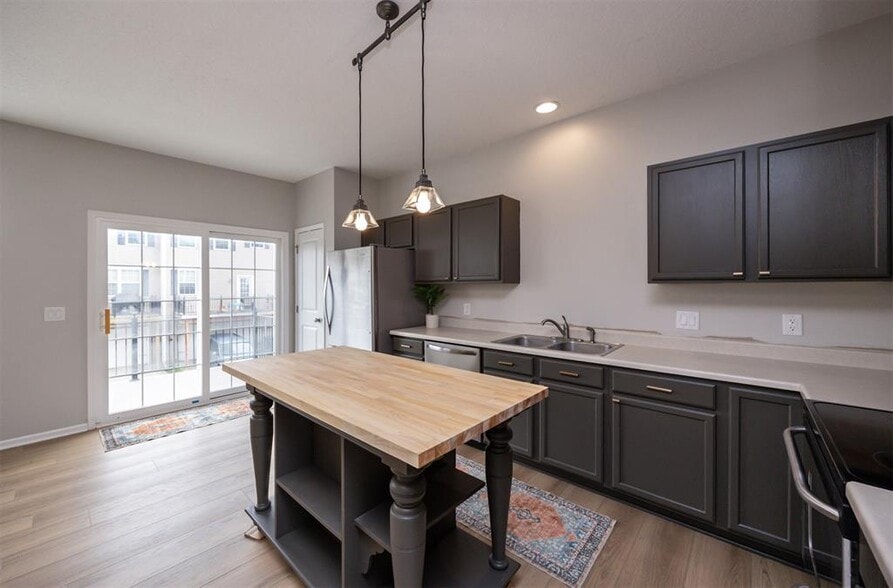 Kitchen: Countertops are now hard stone and faucet is matte black - 928 NE Kamies Ln