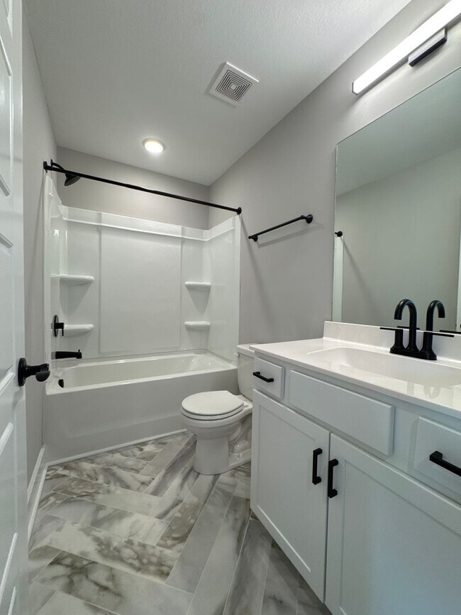 Building Photo - “Stylish 3BR End-Unit | Open Concept | Quartz Kitchen | Garage + Deck