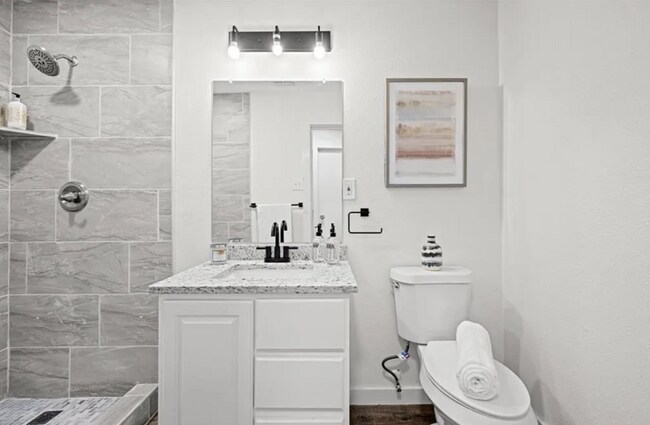Stone accents are in the shower area and new granite. - 5401 Burton Ln