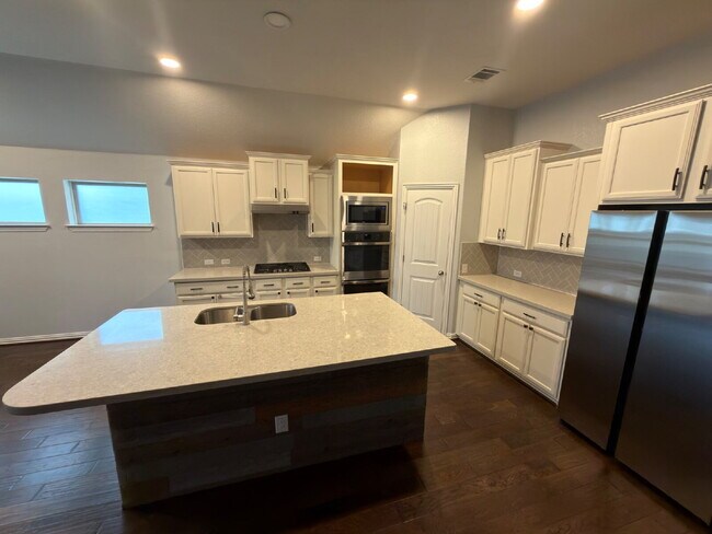 Building Photo - Four bed two bath on a corner lot with a pool in Sunfield. Gas cook top, double ovens. Open kitch...