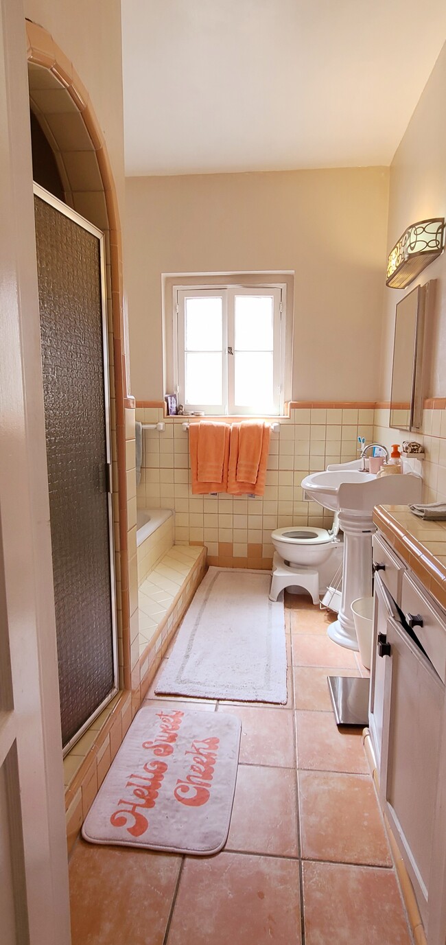 Vintage bathroom with original tile (updated tile on floors). Separate bath and shower. - 1003 S Holt Ave