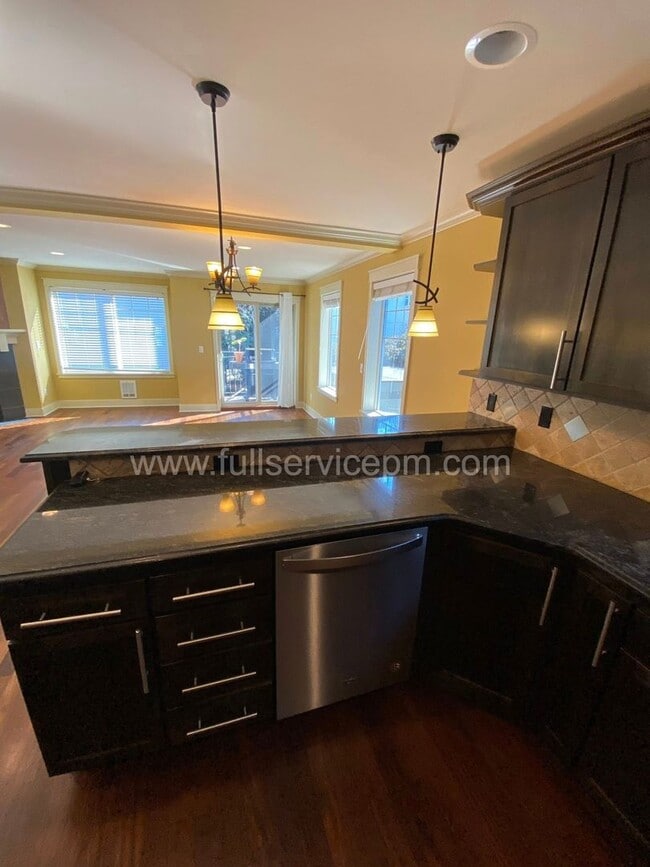 Building Photo - Spacious townhome with private backyard, garage parking, multiple decks, and a dedicated home off...
