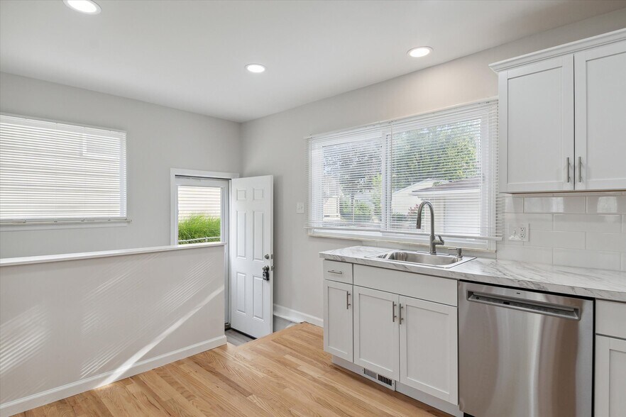Exit to backyard and entrance to stairs down to basement. - 9244 Northern Ave