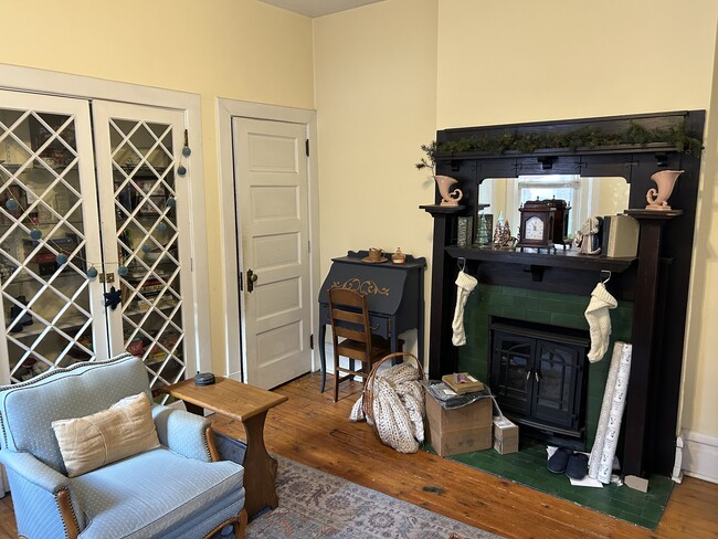 Living room with built in closet, door to closet and fireplace - 1217 Resaca Pl