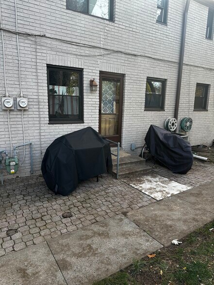 Patio area and common ground backyard. Out rear door. - 189 Newman St