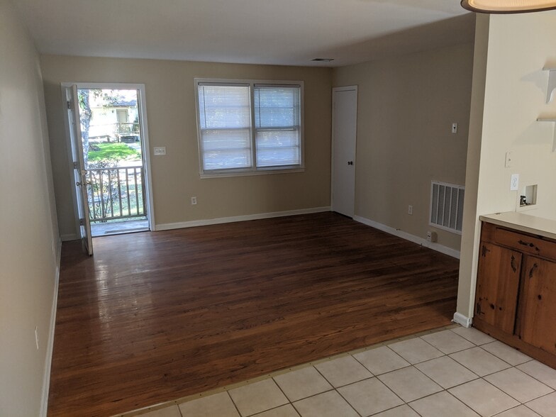 Bright, open living room featuring hardwood-style flooring and generous natural light. - 1527 Brookbank Ave