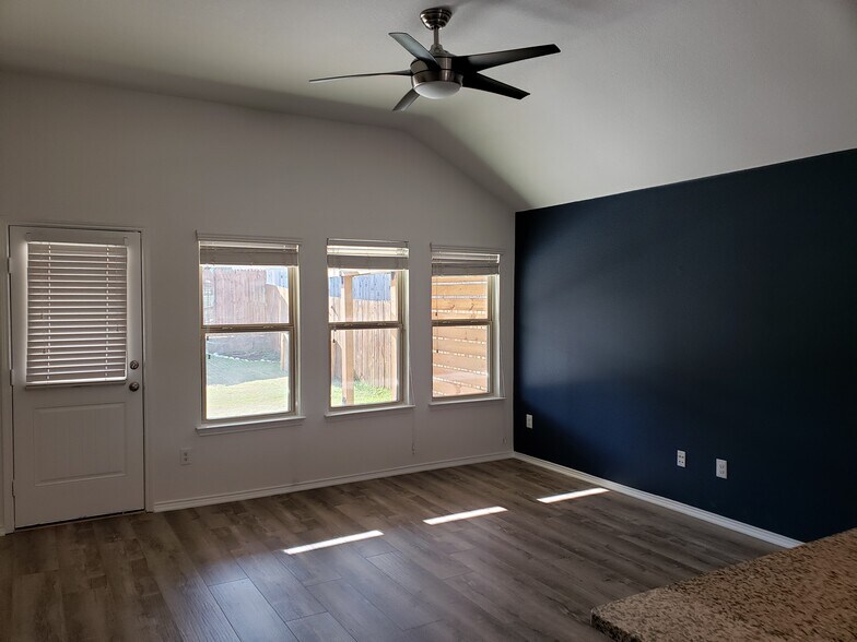 Large family room with cute navy accent wall. - 14557 Serrano Ridge Rd