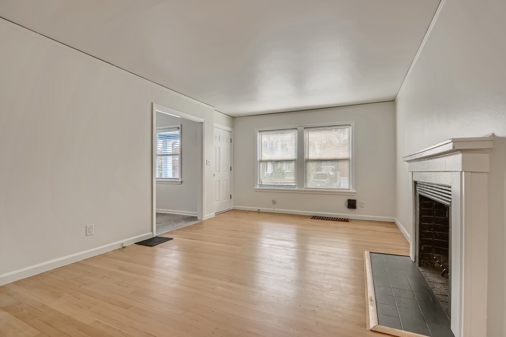 Sun-filled living room with wood burning fireplace - 451 NE Sumner St