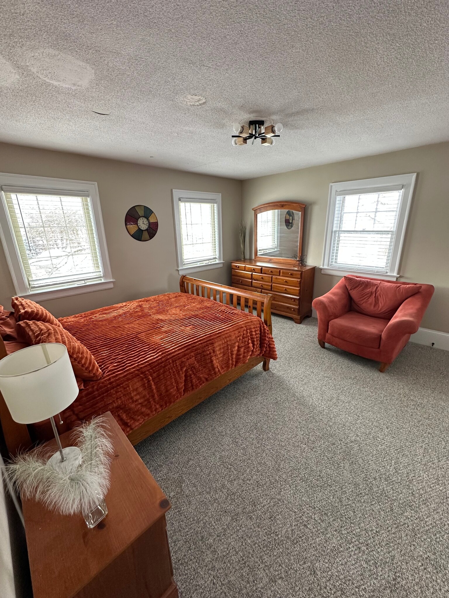 large comfy bedroom with chair and mirrors - 201 Salt Springs Rd