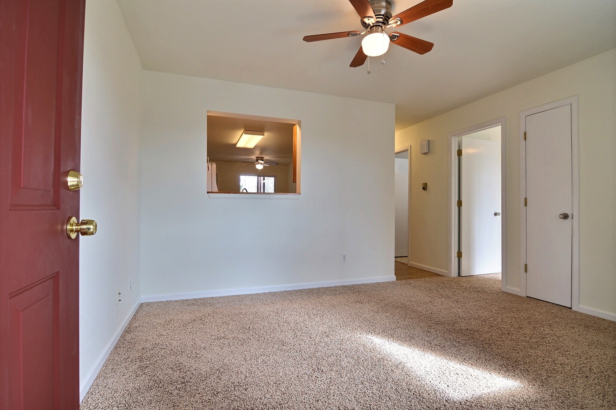 Living room with view into the kitchen - 3210 W County Rd 52 E
