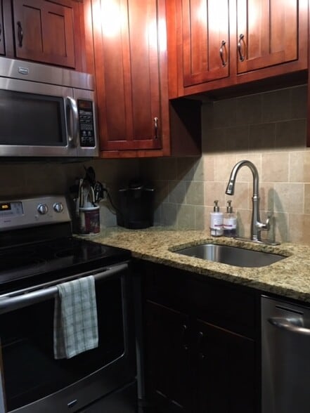 Kitchen w/ stainless steel appliances - 1331 Vermont Ave NW