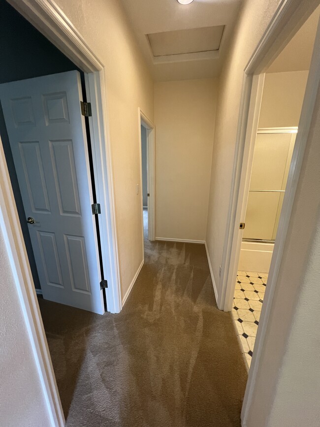 hallway to two smaller rooms and bathroom with tub/shower - 3921 NW Banff Dr