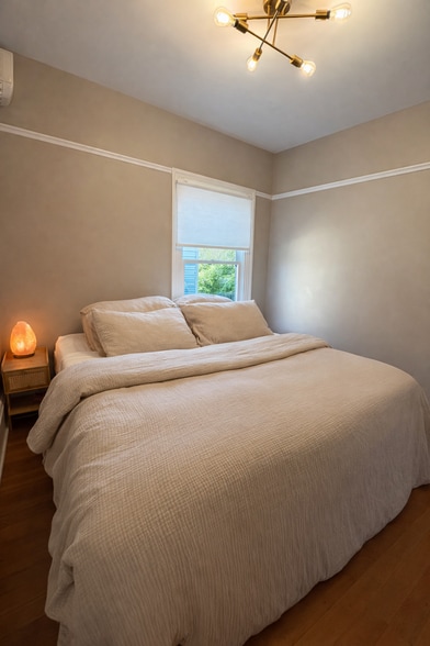 First bedroom on the main floor. This is a king sized bed. (Not included) - 604 NE Shaver St