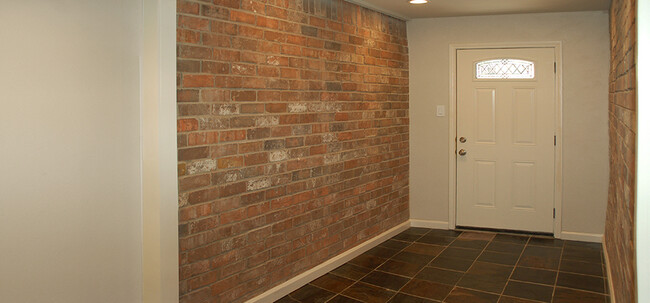 Entry features exposed brick walls - 8710 Park Ln