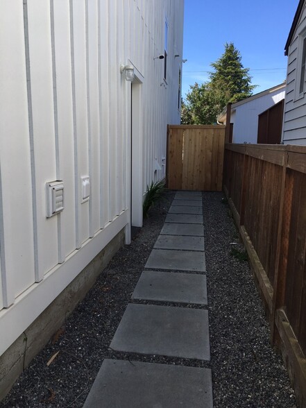 Side of main house and entry door to lower level unit - 7727 Earl Ave NW