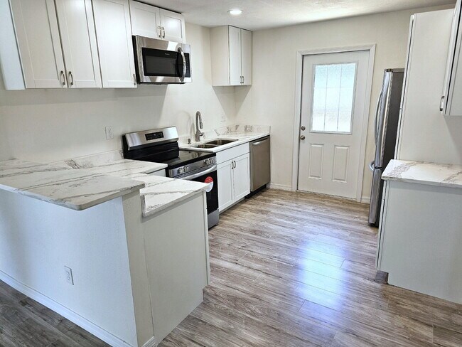 Building Photo - fully renovated 2-bedroom, 1-bathroom home with bonus guest room or office and oversized fenced yard