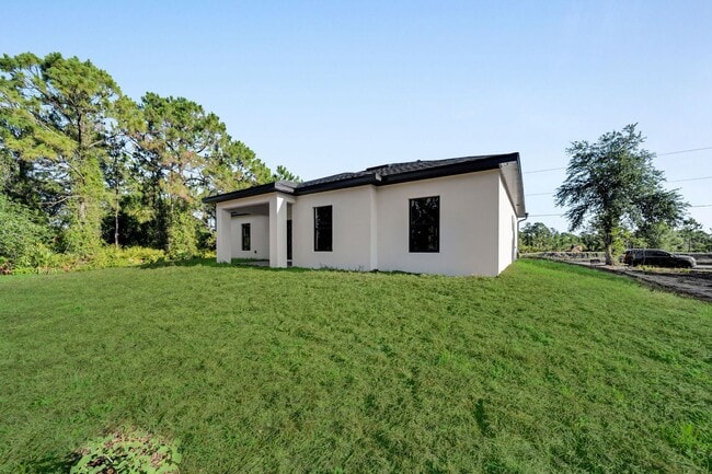 Building Photo - Brand-New Home in Lehigh Acres – Move-In Ready! FL 33974. Qualify for a deposit-free option and s...