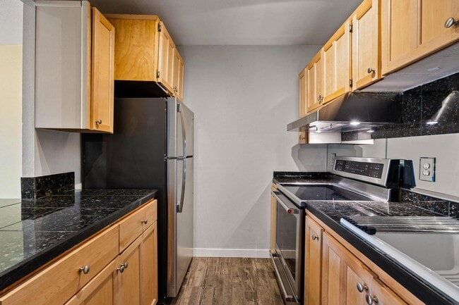 Building Photo - $500 off! Spacious 1-bdrm/1-bath condo in quiet neighborhood. Balcony, 2 parking spaces, fireplac...