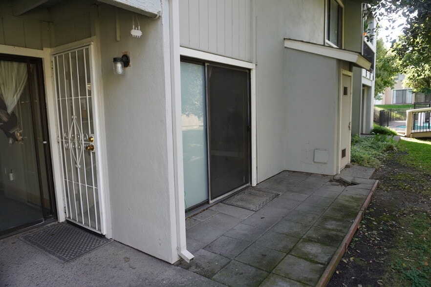 View of back patio showing sliding door and security screen door from family room. - 6518 Embarcadero Dr