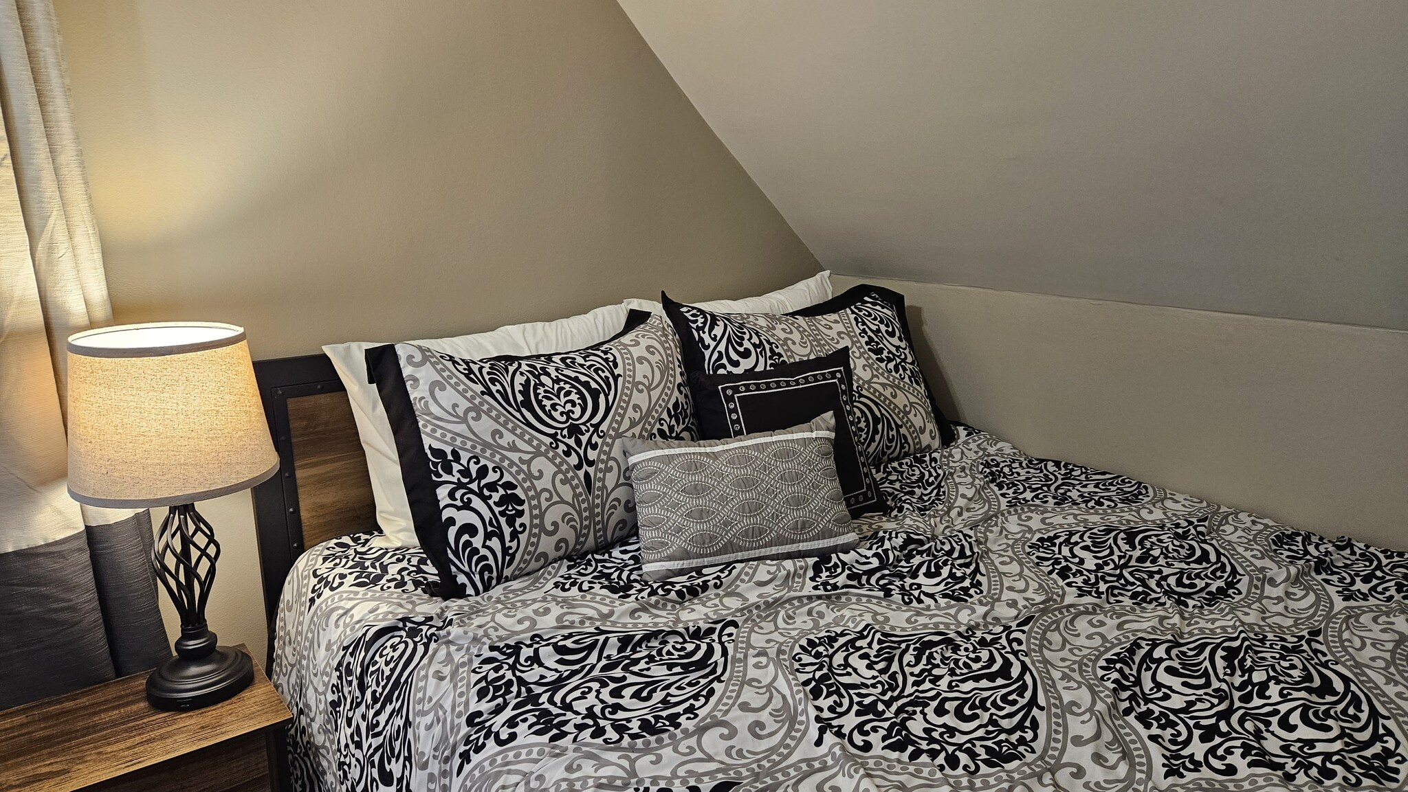 Queen Bed with Plush Bedding and Warm Lighting - 1901 -2301 Fillmore Street NE Minneapolis, MN 55418