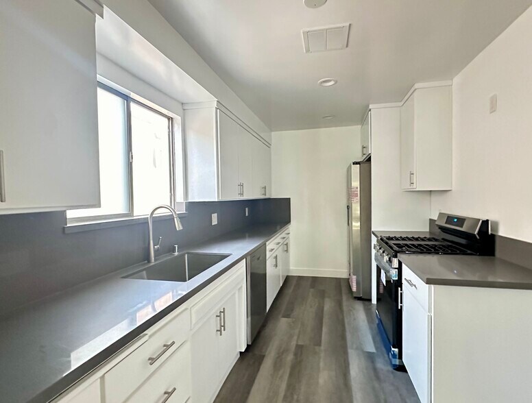 Modern kitchen with all new stainless appliances. - 244 N Almont Dr