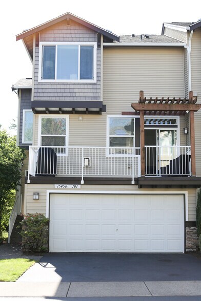 Townhouse front view with two car garage and two private external parking spaces - 15458 SW Mallard Dr