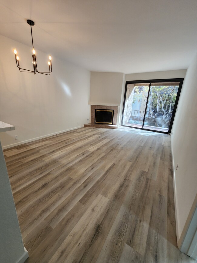 Gas fireplace and floor to ceiling sliding door with good natural lighting - 8675 Falmouth Ave