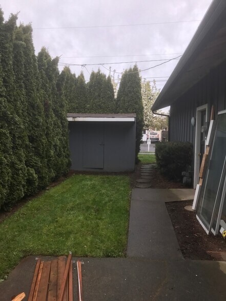 Storage shed, patio, garden beds, and enclosed yard. - 8038 N Wayland Ave