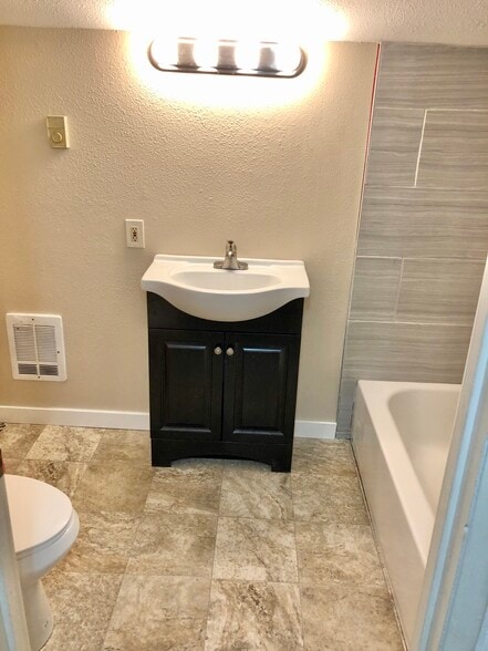 Full bath with new paint, flooring and tile, full size bathroom! - 1007 W Main St