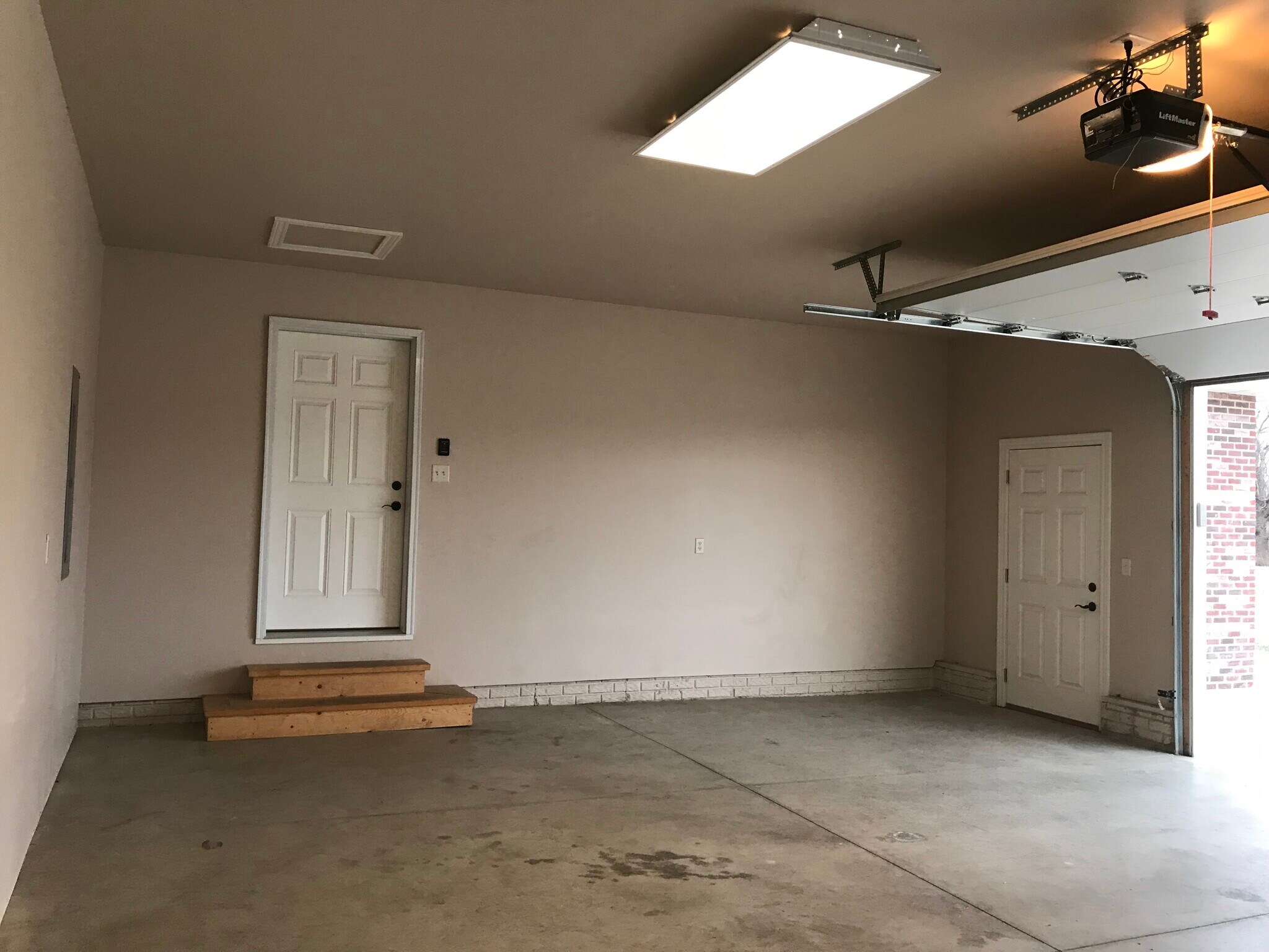 Extra wide, 2 stall garage with door entryway. - 206 Stallion Way