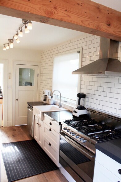 Modern classics. All the right upgrades. Farmhouse sink, 2-inch quartz slab counters, All stainless appliances - range hood, dishwasher, fridge, 36" wide Fischer Paykel 5 burner gas stove, - 2635 NE 30th Ave