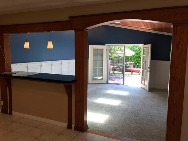 Family room addition with vaulted wood ceiling, skylights, granite countertop, and French doors to r - 14911 Fonthill Ave