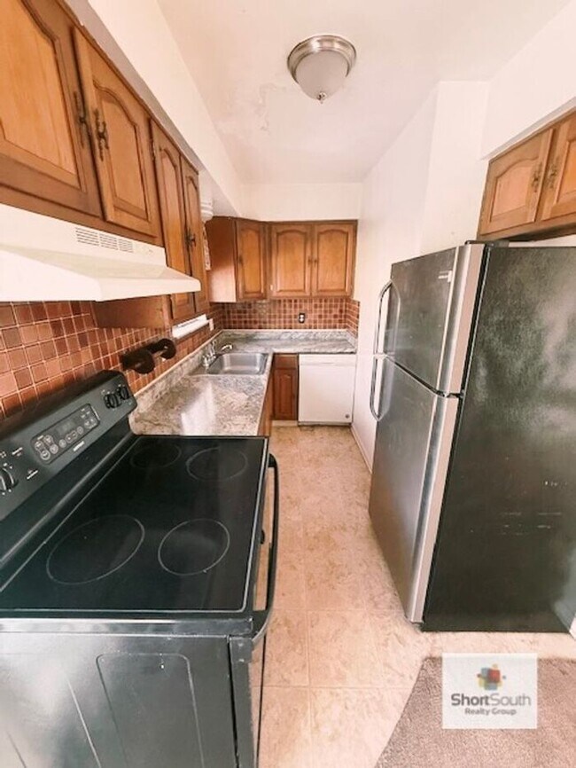 Building Photo - Updated - 2 bed 1.5 bath, Duplex with attached garage and fenced in backyard