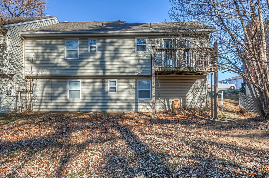 back deck with 4' chain link fenced yard. - 13749 W 62nd St